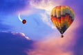 Hot air balloon flying in colorful evening sky with new moon shining. Single red helium balloon flies up into the sky Royalty Free Stock Photo