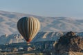 Hot air balloon flying in Goreme national park, fairy chimneys, Royalty Free Stock Photo