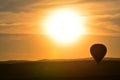 Hot air balloon flying at orange sunset sky Royalty Free Stock Photo