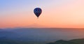 Hot air balloon flying over amazing landscape at sunrise, Cappadocia, Turkey Royalty Free Stock Photo