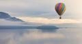 Hot Air Balloon flying over Canadian Mountain Nature Landscape on the Pacific West Coast.