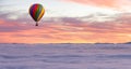 Hot Air Balloon flying over Canadian Nature Landscape on the Pacific West Coast over the clouds.