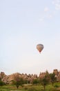 Hot air balloon flying over Cappadocia rocks, Turkey.