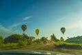 Hot air balloon flying over the road Royalty Free Stock Photo