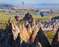 Hot air balloon flying over rock landscape at Cappadocia, Turkey Royalty Free Stock Photo