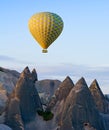 Hot air balloon flying over rock landscape at Cappadocia, Turkey Royalty Free Stock Photo