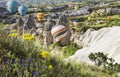 Hot air balloon flying over rock landscape at Cappadocia