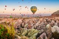 Hot air balloon flying over rock landscape at Cappadocia Turkey Royalty Free Stock Photo