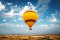 Hot air balloon flying over rock and valley landscape at Cappadocia - Goreme, Turkey. Royalty Free Stock Photo