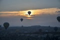 Hot air balloon flying over rocks and valley landscape at Cappadocia near Goreme Turkey Royalty Free Stock Photo