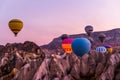 Hot air balloon flying over spectacular Cappadocia, Tourists enjoy the overwhelming views over Cappadocia, Turkey Royalty Free Stock Photo