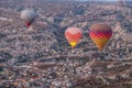 Hot air balloon flying over spectacular Cappadocia, Tourists enjoy the overwhelming views over Cappadocia, Turkey Royalty Free Stock Photo