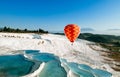 Hot air balloon flying over Travertine pools limestone terraces Royalty Free Stock Photo