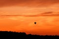 Hot air balloon flying at sunset sky Royalty Free Stock Photo