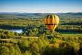 hot air balloon with forested landscape in the background