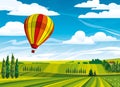 Hot air balloon and green rural meadow