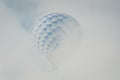 Hot air balloon in hidden in cloud in Teotihuacan