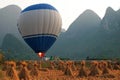 Hot air balloon among the hills and rice fields, Yangshuo, China Royalty Free Stock Photo