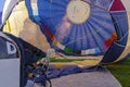 Hot air from a propane burner is heating the air in the antelope of a hot air balloon in Portland, USA