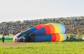 Hot air balloon lying on ground