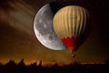 Hot air balloon in a night starry sky and moon Royalty Free Stock Photo