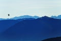 Hot air balloon over mountainous landscape by blue hour Royalty Free Stock Photo