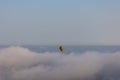 Hot air balloon on over the clouds before sunset time Royalty Free Stock Photo