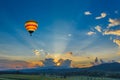 Hot air balloon over the fields at sunset