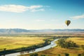 Hot air balloon over lush green fields with clear sky, perfect for text insertion Royalty Free Stock Photo