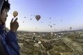 Hot air balloon over the panorama of the valley of Cappadocia Goreme. A man, a young guy is flying in a hot air balloon