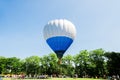 Hot air balloon over the park with blue sky