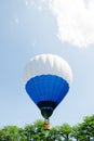 Hot air balloon over the park with blue sky