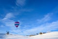 Hot-air balloon over snow covered landscape and small rural village, Bavaria, Germany Royalty Free Stock Photo