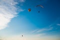 Hot air balloon and paraglider on the sky background