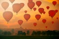 Hot air balloon with people in the basket as birds fly past in the sky Royalty Free Stock Photo