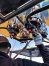 a hot air balloon pilot operates the burner control to heat the air, vertical