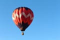 Hot Air balloon in red, white and blue in brilliant blue sky.