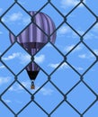 A hot air balloon is seen through a chain link