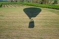 The hot air balloon shadow on farm grounds