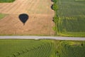 Hot air balloon shadow on field with road. Royalty Free Stock Photo