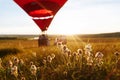 Hot air balloon in the shape of a heart is flying over the flower field at sunset, sunrise Royalty Free Stock Photo