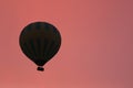 Hot Air Balloon Silhouette Flying In Red Sky At Morning
