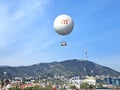 Hot Air Balloon In the Sky in Tbilisi, Georgia on a Sunny Day in April, Mountain and Cityscape in the Background Royalty Free Stock Photo