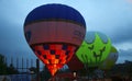 Hot air balloon starting to fly in evening sky