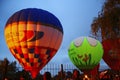 Hot air balloon starting to fly in evening sky