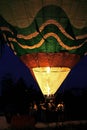 Hot air balloon starting to fly in evening sky