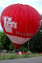 Hot air balloon starting to fly in evening sky