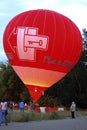 Hot air balloon starting to fly in evening sky