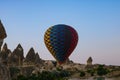 Hot air balloon taking off and fairy chimneys in Cappadocia Royalty Free Stock Photo