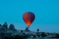 Hot air balloon taking off and fairy chimneys in Cappadocia Royalty Free Stock Photo